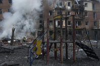 Ukrainian State Emergency Service firefighters work to extinguish a fire at the scene of a Russian shelling in the town of Vyshgorod outside the capital Kyiv, Ukraine, Wednesday, Nov. 23, 2022. Authorities reported power outages in multiple cities of Ukraine, including parts of Kyiv, and in neighboring Moldova after renewed strikes Wednesday struck Ukrainian infrastructure facilities. (AP Photo/Efrem Lukatsky)
