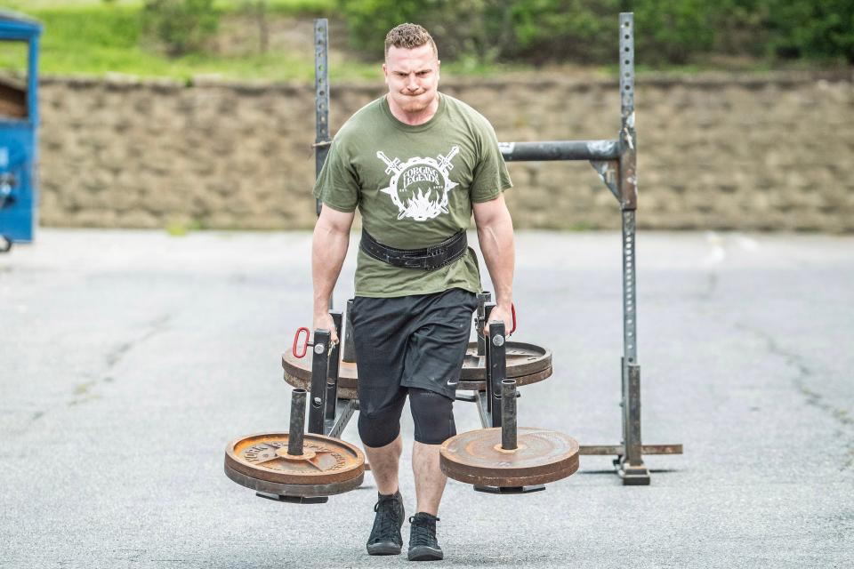 Bradie Crandall does the farmer's walk with 450 pounds at the Training Center near New Castle on Thursday, Aug. 3, 2023. Crandall, a chemical engineering doctoral candidate at UD, is among the nation's top powerlifters and a vegan.