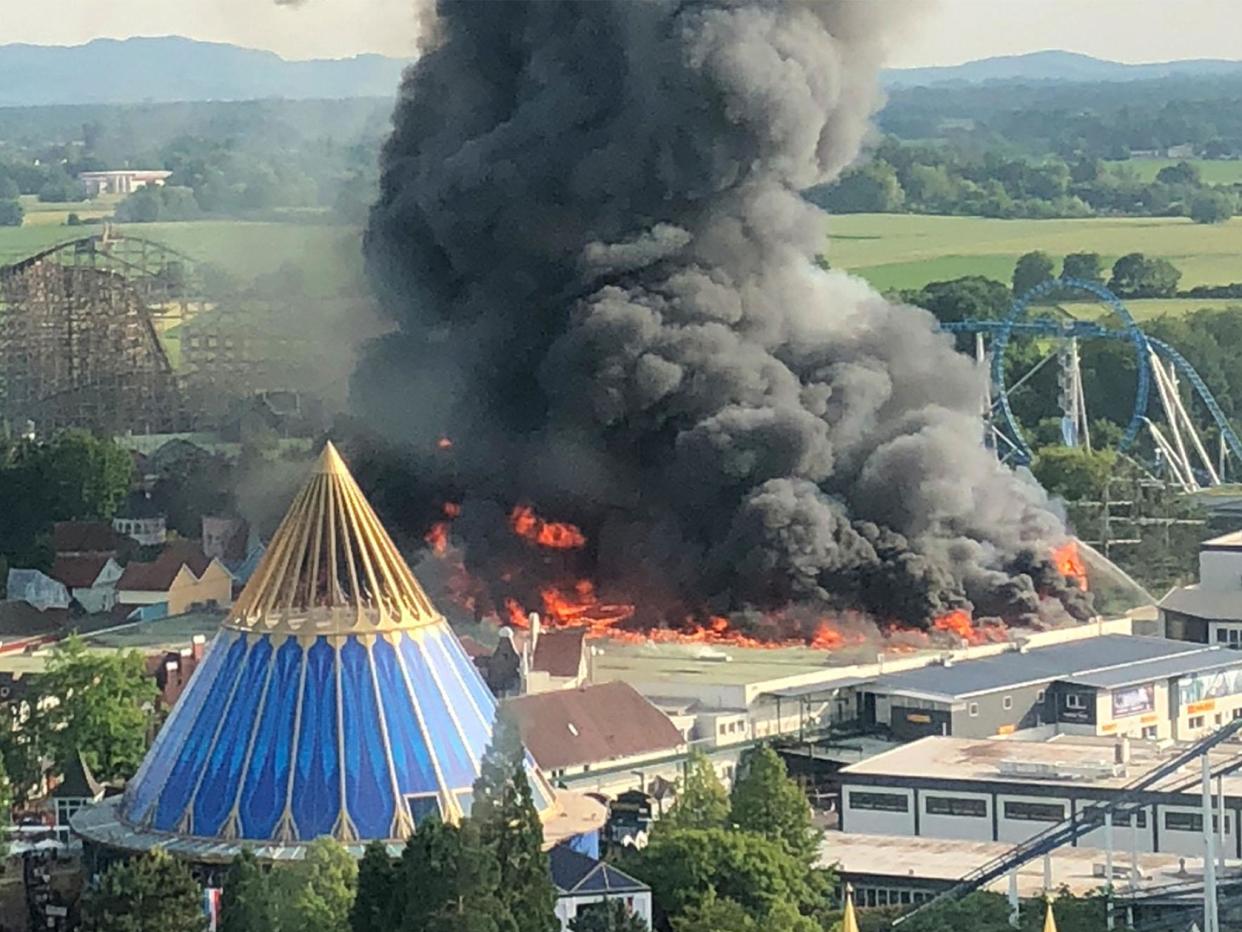 A black column of smoke rises from a burning warehouse at the Europa-Park in Rust, Germany: Christine Gertler/AFP/Getty Images