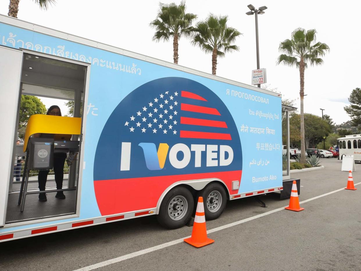 A voter prepares her ballot in a voting booth during early voting for the California presidential primary election: Getty Images