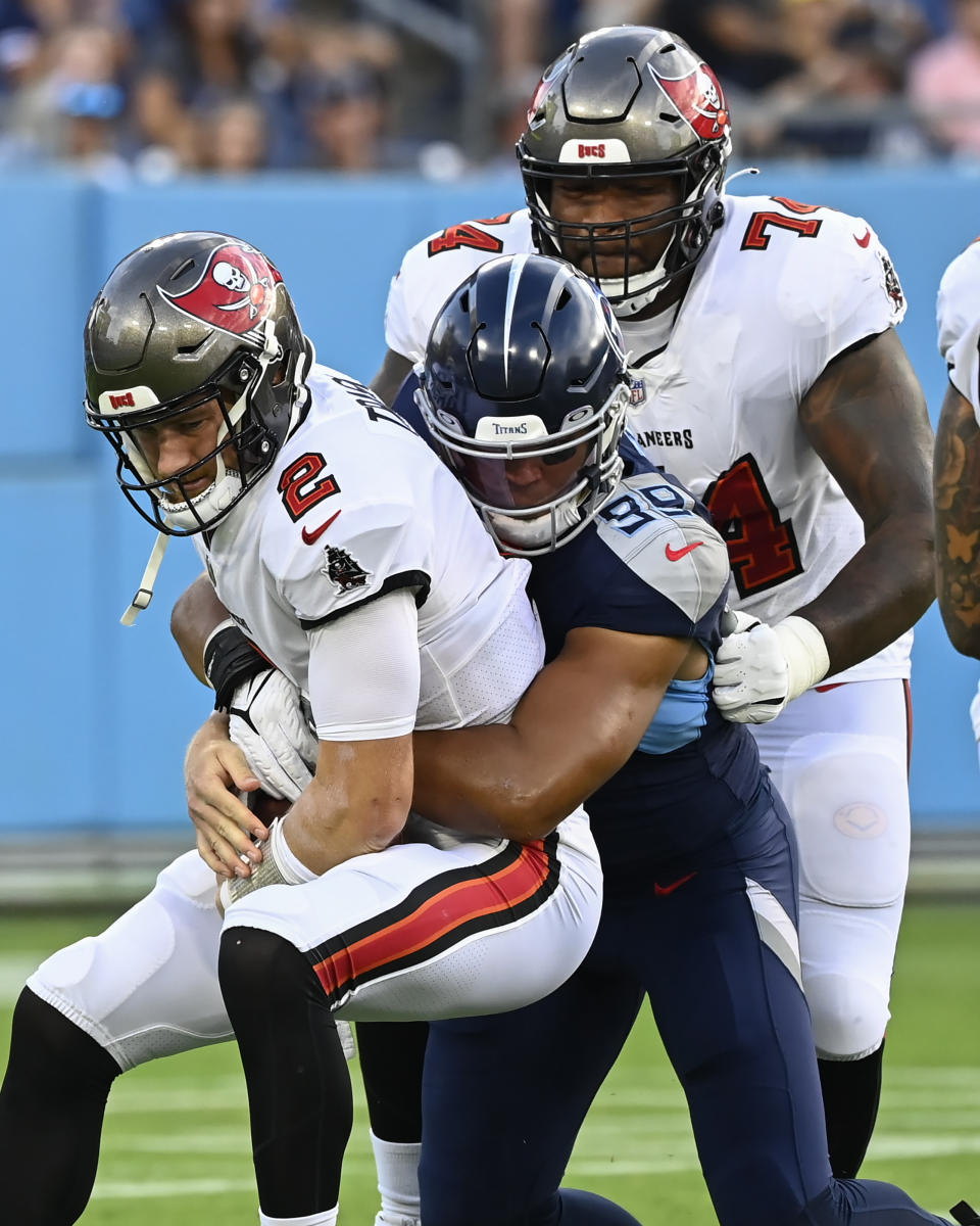 Tennessee Titans linebacker Rashad Weaver (99) stops Tampa Bay Buccaneers quarterback Kyle Trask (2) in the first half of a preseason NFL football game Saturday, Aug. 20, 2022, in Nashville, Tenn. (AP Photo/Mark Zaleski)