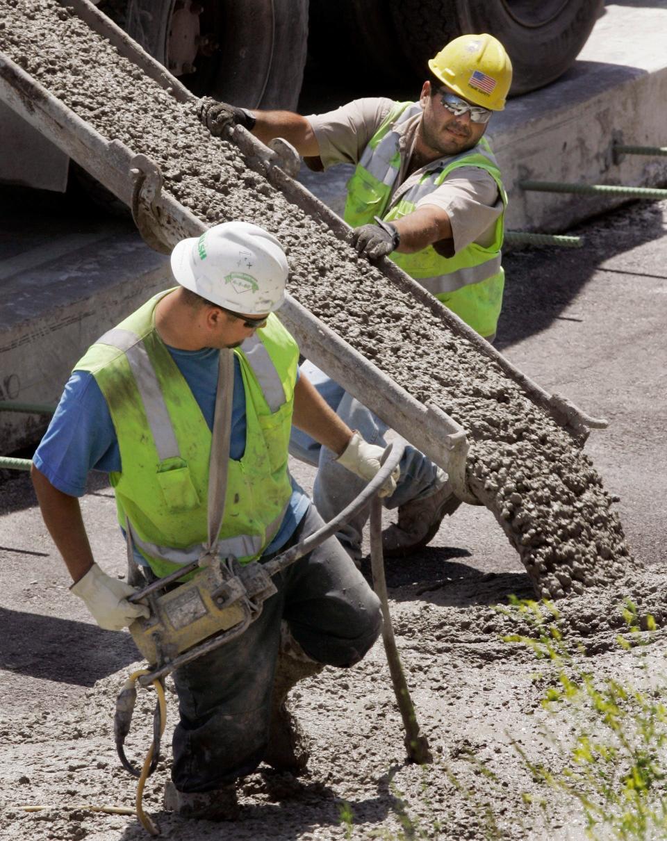 Workers pour concrete at a construction site on the Dan Ryan Expressway on Chicago's South Side Wednesday, June 6, 2007. The productivity of American workers slowed sharply in the first three months of this year but wage pressures eased as well, providing evidence that inflation is being restrained.