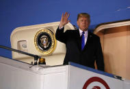 U.S. President Donald Trump waves as he disembarks Air Force One after arriving in Singapore June 10, 2018. REUTERS/Jonathan Ernst