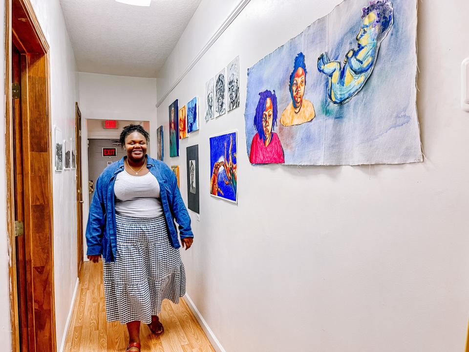 Trinity Anthony, pictured at The Bottom on Aug. 4, with some of the work on display for her first solo exhibition that will be open to the public through Saturday Aug. 13.