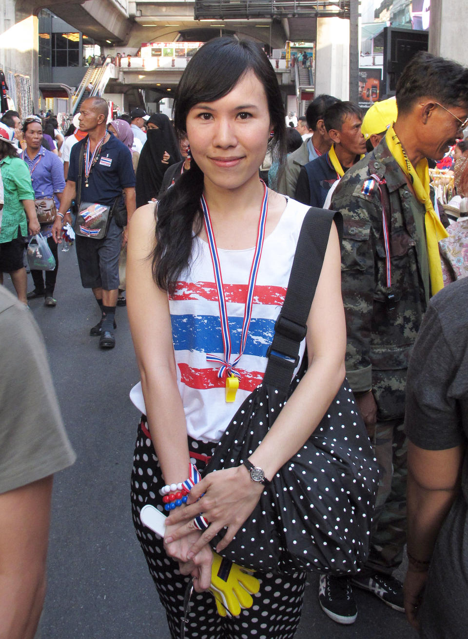 In this photo taken Tuesday, Jan. 14, 2014, Thai anti-government protester Lanalee Ngamdee, 35, poses for a photo near a protest site in Bangkok’s commercial district, Thailand. “I want to see reforms for everything because the Thaksin regime has seeped in to control every mechanism in the society and allowed the government to abuse their power. There’s no legitimacy in using the majority of the votes to corrupt. This is why people rise up against you," said Lanalee. (AP Photo/Thanyarat Doksone)