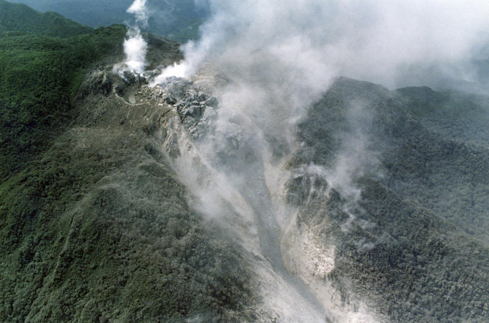 FILE - In this June 8, 1991, file photo, white smoke billows from the crater of Mount Unzen in Shimabara, southern Japan, before the volcano erupted again. The large scale eruption sent super hot debris and gas down the mountain's east slope. (AP Photo/Koji Sasahara)