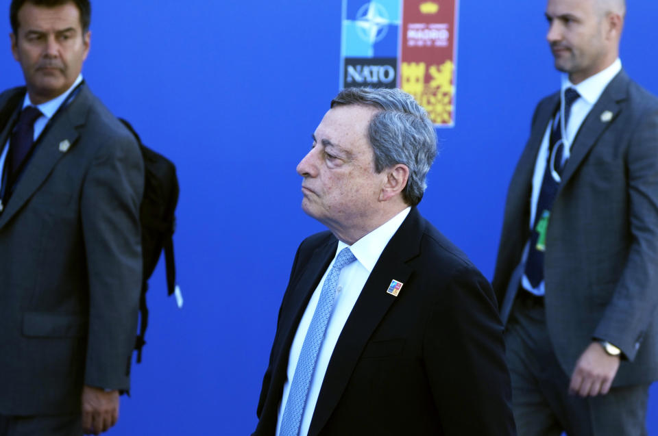 FILE - Italian Prime Minister Mario Draghi, center, arrives for the NATO summit in Madrid, Spain on Wednesday, June 29, 2022. Italian Prime Minister Mario Draghi's offer to resign has sent unsettling ripples through financial markets, bringing back bad memories of Europe's debt crisis a decade ago and complicating the European Central Bank's job as it raises interest rates for the first time in 11 years to combat record inflation. (AP Photo/Paul White, File)