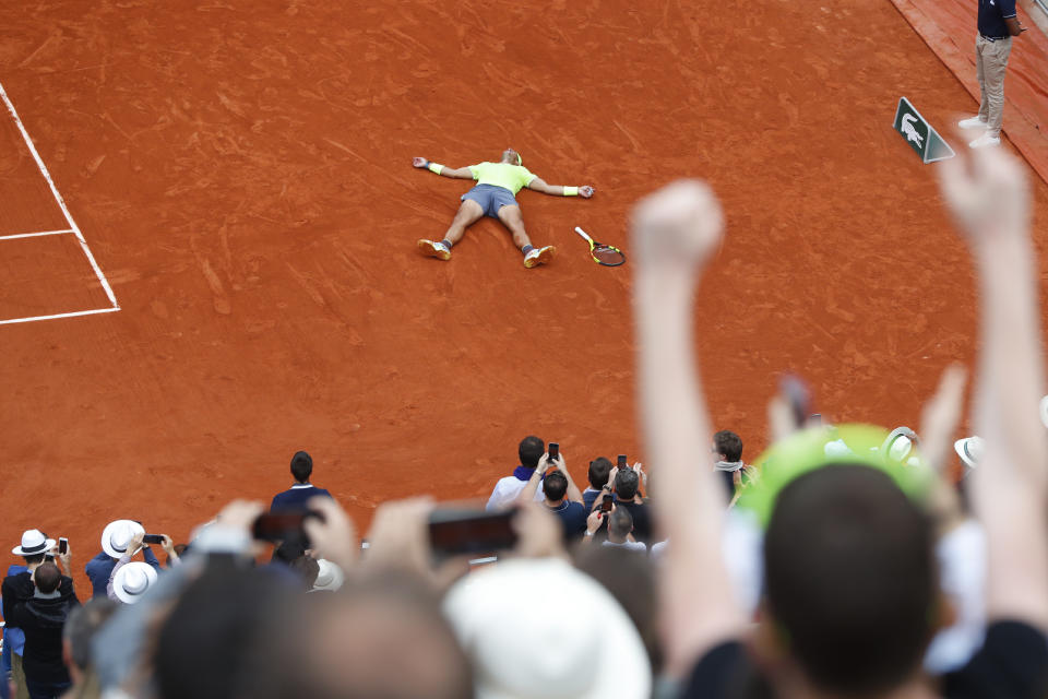 Spain's Rafael Nadal lays on the clay as he defeats Austria's Dominic Thiem during the men's final match of the French Open tennis tournament at the Roland Garros stadium in Paris, Sunday, June 9, 2019. Nadal won 6-3, 5-7, 6-1, 6-1. (AP Photo/Pavel Golovkin)