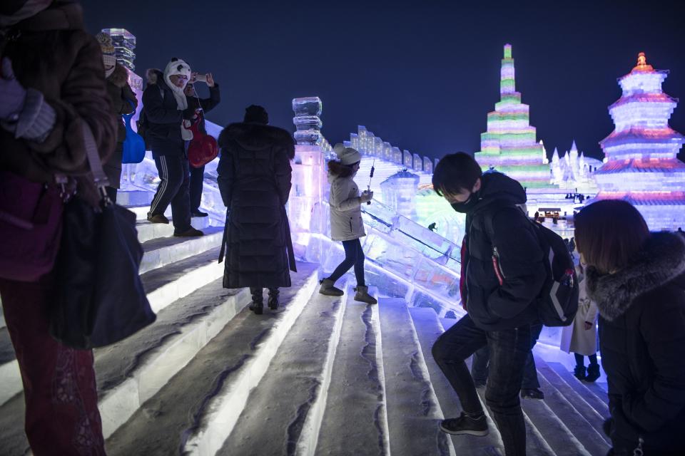 Visitors look at ice sculptures during the annual Harbin Ice and Snow Festival in Harbin, in China’s northeast Heilongjiang province on Jan. 6, 2019. (Photo: Fred Dufour/AFP/Getty Images)