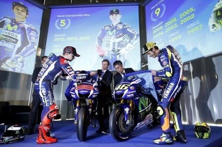 Yamaha's MotoGP riders Jorge Lorenzo (L) and Valentino Rossi unveil the new Yamaha YZR-M1 for the 2016 season in Barcelona, Spain, January 18, 2016. REUTERS/Albert Gea