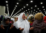 Nahed Ahmed Zeead (C), 51, of Iraq, takes part in the jenazah. REUTERS/Lucy Nicholson