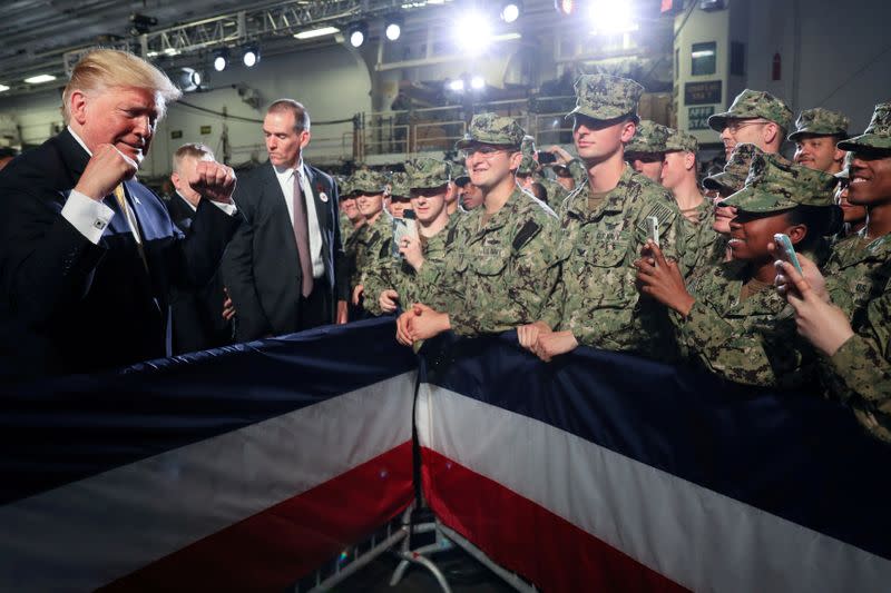 FILE PHOTO: U.S. troops take photos of U.S. President Trump aboard the USS Wasp in Yokosuka