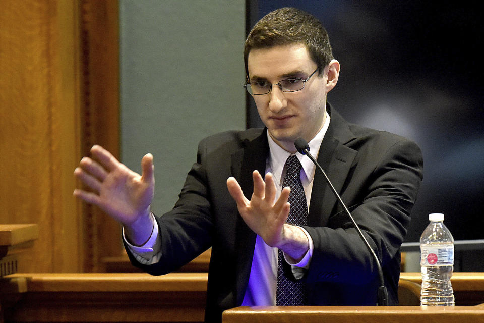 Defendant Joseph Elledge testifies how he pushed his wife Mengqi Ji, during a shoving match before she fell and hit her head in Oct. 2019 during his murder trial Wednesday, Nov. 10, 2021, in Columbia, Mo. Elledge is accused of killing his 28-year-old wife, whom he reported missing in October 2019. Her remains were found in March in a park near Columbia, Mo. (Don Shrubshell/Columbia Daily Tribune via AP, Pool)