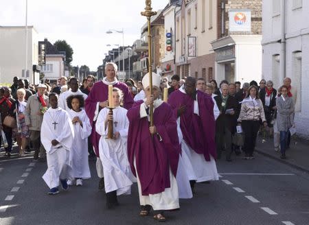 Archbishop of Rouen and Primate of Normandy Mgr Dominique Lebrun leads a procession to the memory of slain French priest, Father Jacques Hamel, in Saint-Etienne-du-Rouvray, France, October 2, 2016. REUTERS/Steve Bonet