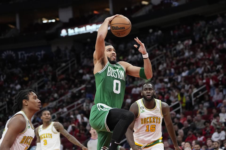 Boston Celtics' Jayson Tatum (0) goes up to attempt a dunk against the Houston Rockets during the first half of an NBA basketball game Monday, March 13, 2023, in Houston. (AP Photo/David J. Phillip)