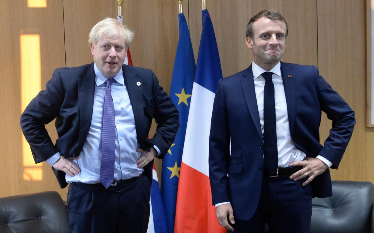 French President Emmanuel Macron (L) is taking a hardline approach to negotiations with Boris Johnson (R) over fishing and other outstanding issues - Johanna Geron /Reuters