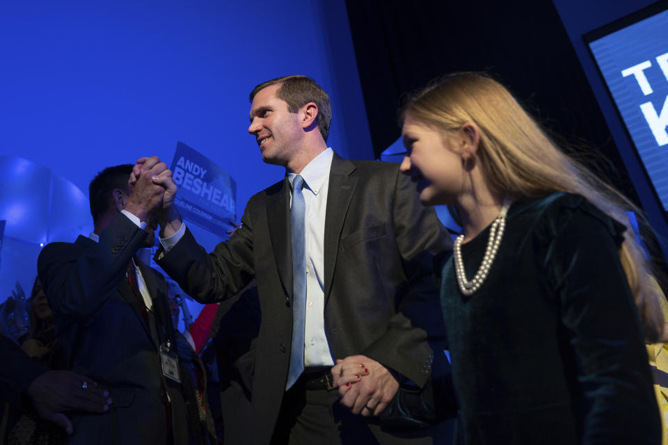 Democratic gubernatorial candidate and Kentucky Attorney General Andy Beshear walks with his daughter Lila to speak to supporters at the Kentucky Democratic Party election night watch event, Tuesday, Nov. 5, 2019, in Louisville, Ky. (AP Photo/Bryan Woolston)