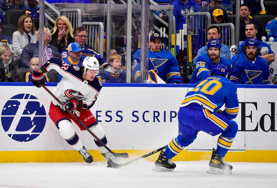 Nov 27, 2021; St. Louis, Missouri, USA;  Columbus Blue Jackets center Alexandre Texier (42) and St. Louis Blues left wing Brandon Saad (20) battle for the puck during the first period at Enterprise Center. Mandatory Credit: Jeff Curry-USA TODAY Sports