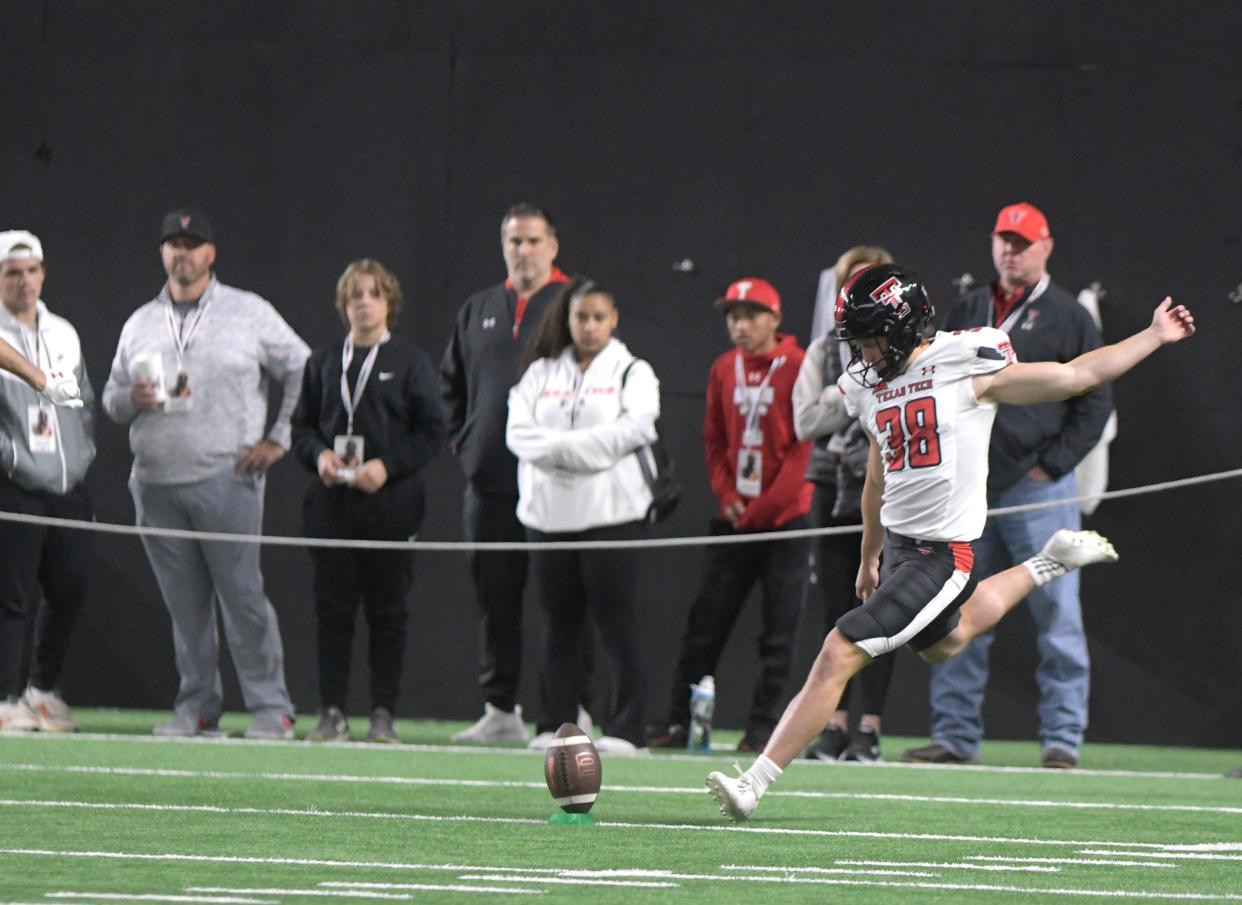 Reese Burkhardt kicks off during the Texas Tech football spring game on Saturday in the Sports Performance Center. Burkhardt made a 54-yard field goal to send the game to overtime, then kicked a 43-yard game winner in the first extra period.