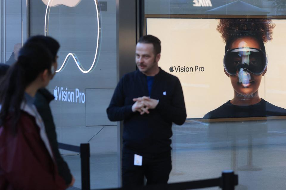 An Apple employee organizes the line for the doors to open at the launch of the Apple Vision Pro at Apple The Grove in Los Angeles, California, on February 2, 2024.