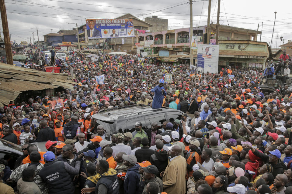 FILE - Kenyan presidential candidate Raila Odinga, center, waves to supporters during an election campaign rally with his running mate Martha Karua in the low-income Kawangware neighborhood of Nairobi, Kenya on July 16, 2022. Kenya's Aug. 9 election is ripping open the scars of inequality and corruption as East Africa's economic hub chooses a successor to President Uhuru Kenyatta. (AP Photo/Brian Inganga, File)