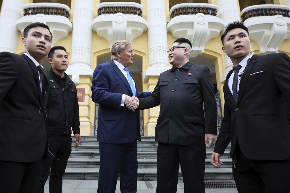 U.S. President Donald Trump impersonator Russell White, center left, and North Korean leader Kim Jong-un impersonator Howard X pose for photos outside the Opera House in Hanoi, Vietnam, Friday, Feb. 22, 2019. The second summit between Trump and Kim will take place in Hanoi on Feb. 27 and 28. (AP Photo/Minh Hoang)