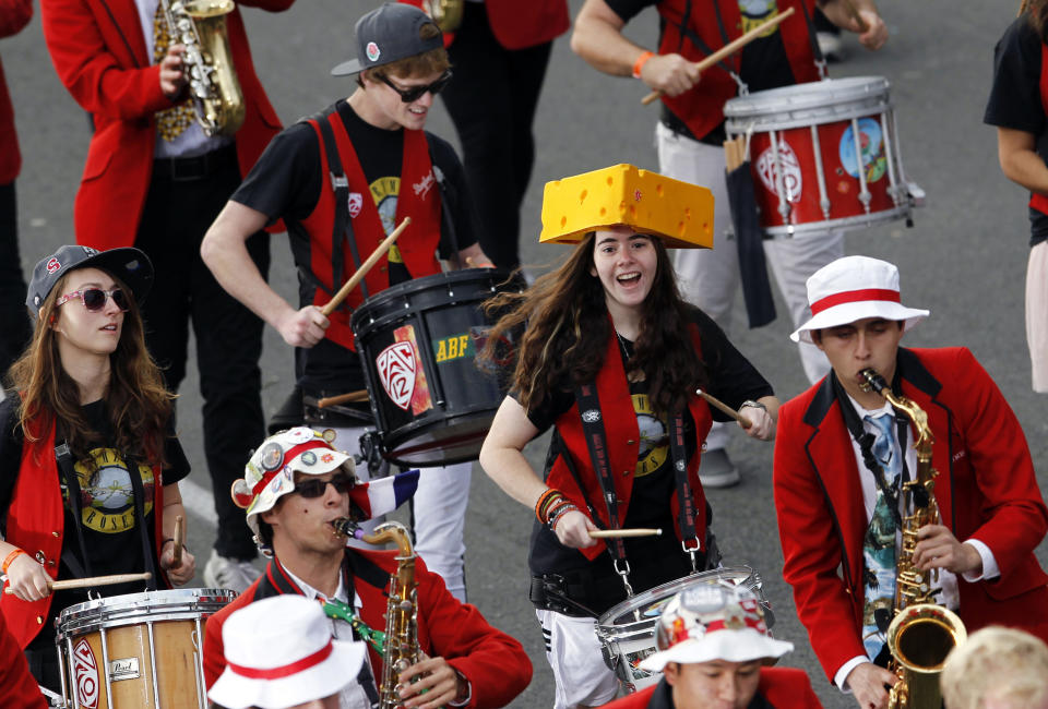 A member of the Stanford University Marching Band wears a Wisconsin Cheese head hat while performing in the 124th Rose Parade in Pasadena, Calif., Tuesday, Jan. 1, 2013. (AP Photo/Patrick T. Fallon)