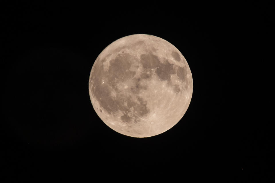 the full moon in a black night sky