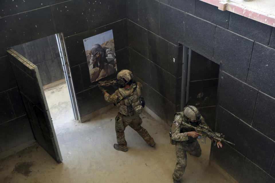 FILE - In this July 17, 2021 file photo, Afghan Army Special forces take part in a training exercise after a three-month training program at the Kabul Military Training Center, in Kabul, Afghanistan. The US and NATO have promised to pay $4 billion a year until 2024 to finance Afghanistan’s military and security forces, which are struggling to contain an advancing Taliban. Already since 2001, the U.S. has spent nearly $89 billion to build, equip and train the forces. (AP Photo/Rahmat Gul, File)