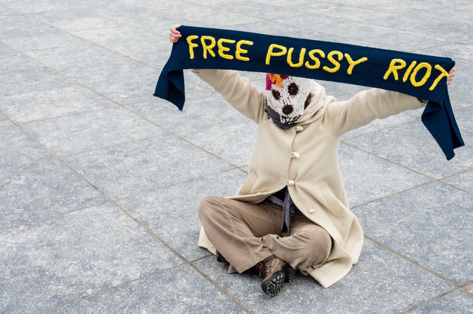 An Amnesty International member holds a hand knitted Pussy Riot fan scarf to support the members of the Russian punk band, in Brussels on Sunday Feb. 17, 2013. (AP Photo/Geert Vanden Wijngaert)