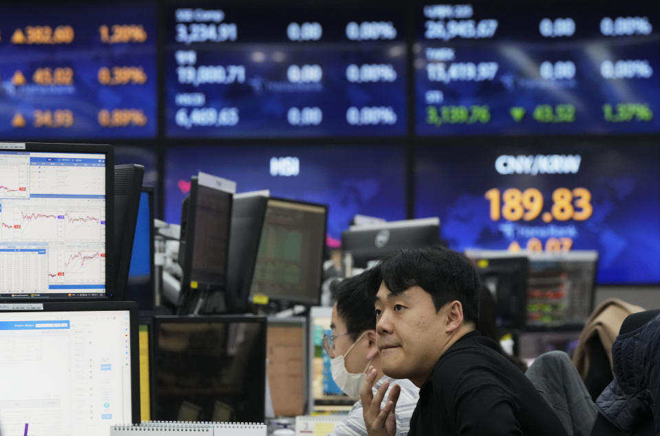 A currency trader watches monitors at the foreign exchange dealing room of the KEB Hana Bank headquarters in Seoul, South Korea, Tuesday, March 21, 2023. sian stock markets followed Wall Street higher on Tuesday ahead of a Federal Reserve decision on another possible interest rate hike amid worries about global banks. (AP Photo/Ahn Young-joon)