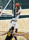 Michigan State's Rocket Watts (2) shoots against Iowa's Luka Garza (55) during the second half of an NCAA college basketball game, Tuesday, Feb. 25, 2020, in East Lansing, Mich. Michigan State won 78-70. (AP Photo/Al Goldis)