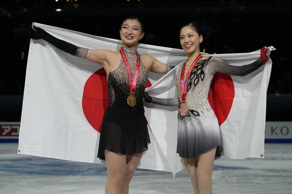 Gold medalist Japan's Kaori Sakamoto, left and bronze medalist Japan's Hana Yoshida pose for photos during the victory ceremony for the Women's Final in the ISU Grand Prix of Figure Skating Final held in Beijing, Saturday, Dec. 9, 2023. (AP Photo/Ng Han Guan)