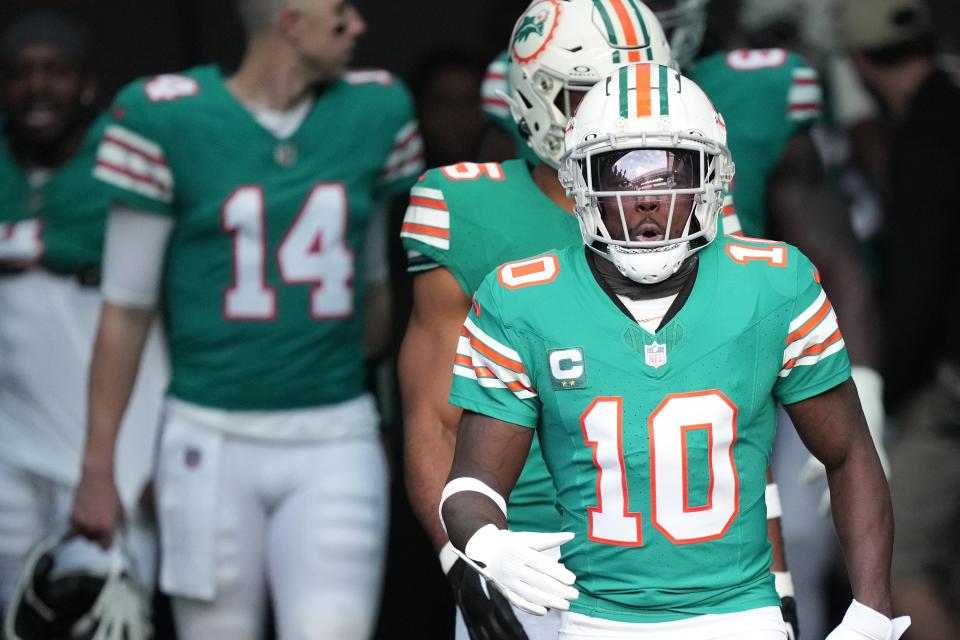 Miami Dolphins wide receiver Tyreek Hill (10) heads out to warm-up before the NFL game against the Dallas Cowboys at Hard Rock Stadium in Miami Gardens, Dec. 24, 2023.