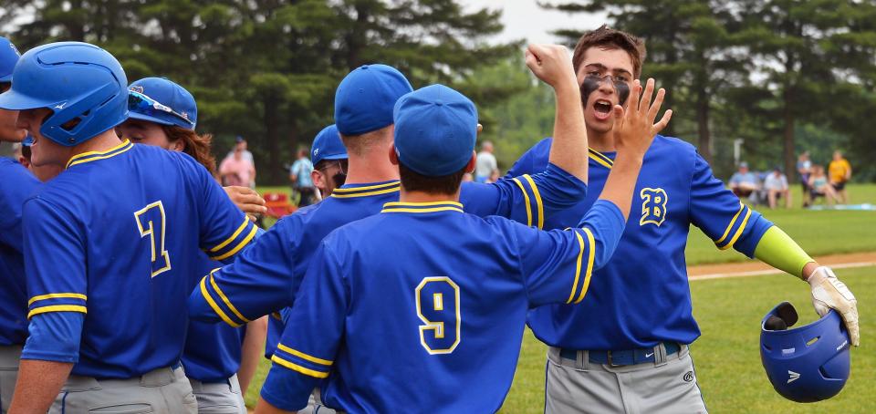 Clear Spring's Hutson Trobaugh, right, is greeted by teammates in front of the dugout after hitting a first-inning home run against South Carroll in the Class 1A quarterfinals. Trobaugh's homer ignited the Blazers to a 5-0 victory to advance to the state semifinals.