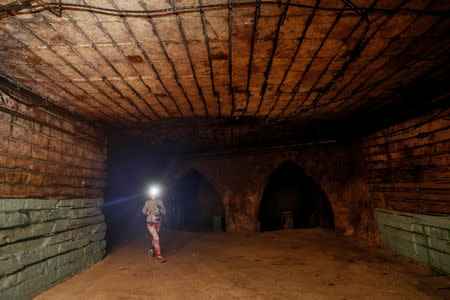 A participant runs during the "Milestii Mici Wine Run 2019" race, at a distance of 10 km in the world's largest wine cellars in Milestii Mici, Moldova January 20, 2019. Picture taken January 20, 2019. REUTERS/Gleb Garanich