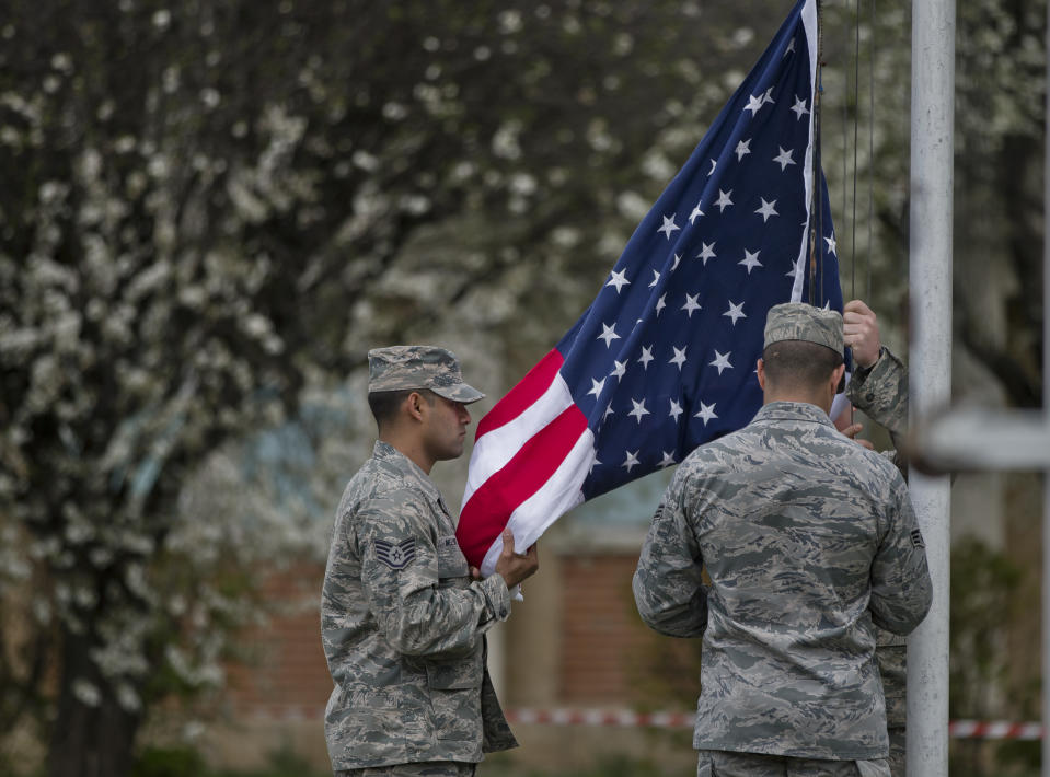 Members of the US air force raise the US flag during a ceremony at a Romanian air base in Campia Turzii, Romania, Thursday, April 10, 2014. Some 450 U.S. and Romanian troops are taking part in the Dacian Viper 2014 joint military exercise in Transylvania, northwestern Romania flying U.S. F-16 fighter jets of the U.S. 31st Fighter Wing alongside Romanian Mig-21 Lancers.The weeklong exercise, the fourth of its kind, was planned before Russia’s recent annexation of Crimea, according to officials.(AP Photo/Vadim Ghirda)