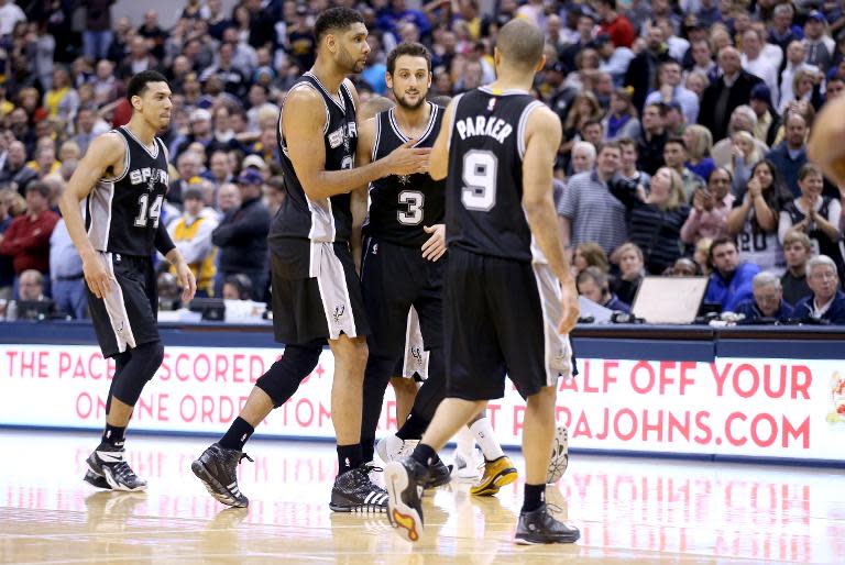 San Antonio Spurs' Tim Duncan hugs teamamte Marco Belinelli during a game at Bankers Life Fieldhouse on February 9, 2015