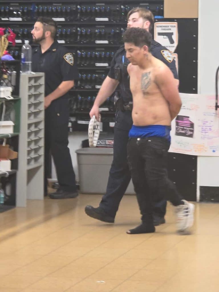 A photo obtained by The Post shows the suspect and his tattoo at the precinct where he was processed. obtained by the NY Post