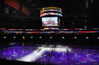 Boston Bruins and Philadelphia Flyers players stand for the national anthem before the Bruins' home-opener NHL hockey game, Thursday, Jan. 21, 2021, in Boston. (AP Photo/Elise Amendola)