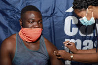 33-year-old Noesqui Muanza receives a dose of the Pfizer COVID-19 vaccine at the Vaccination Centre of Hope at the Cape Town International Convention Centre in Cape Town, South Africa, Friday, Dec. 3, 2021. The mass Covid-19 vaccination site is closing today after vaccinating more than 136 000 people at the Western Cape's first mass vaccination centre. (AP Photo/Nardus Engelbrecht)