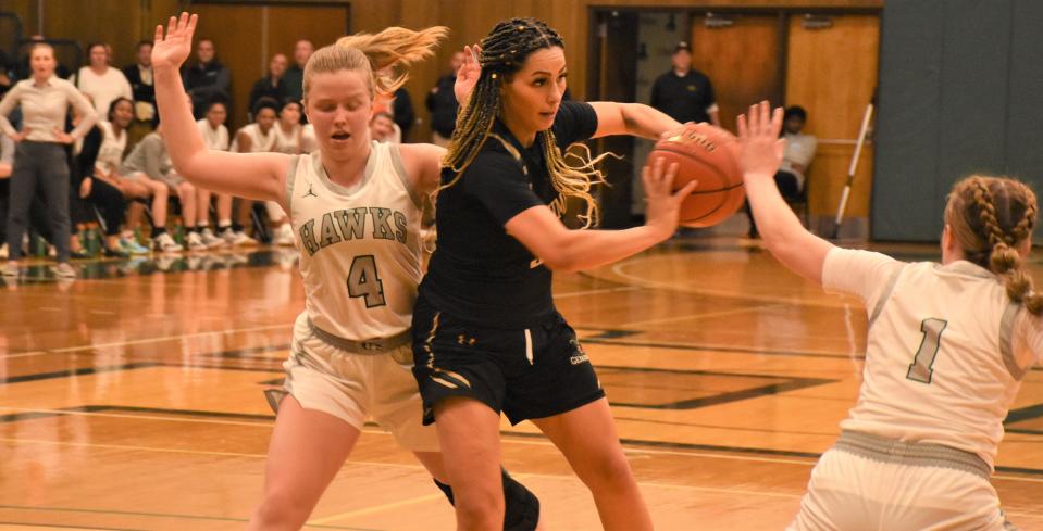 Herkimer College's Ajla Sejdic throws a pass between Mohawk Valley Community College defenders Mackenzie Hess (4) and Sophia Murray (1) Tuesday, Nov. 29, 2022, in Herkimer, New York.