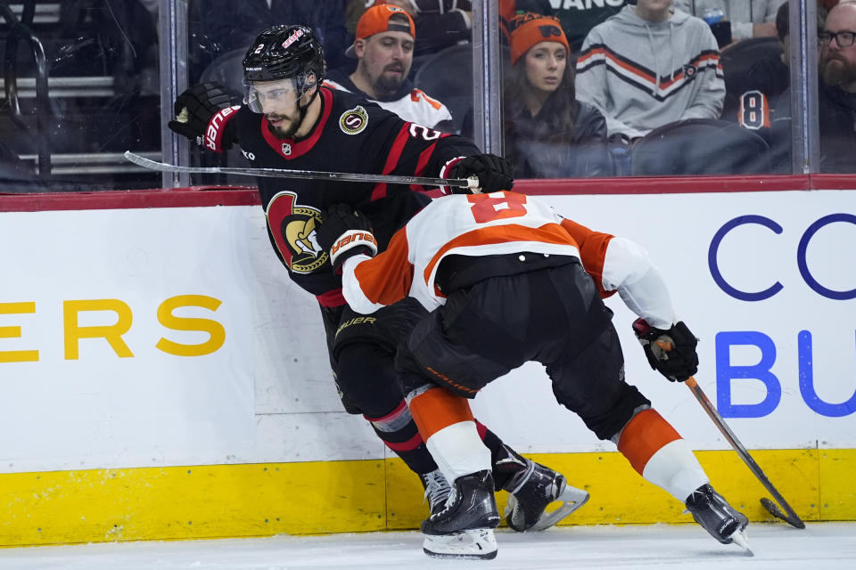 Ottawa Senators' Artem Zub, left, tries to get past Philadelphia Flyers' Cam York during the third period of an NHL hockey game, Saturday, March 2, 2024, in Philadelphia. (AP Photo/Matt Slocum)