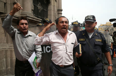 People protest against Peru's President Pedro Pablo Kuczynski's government near the Government Palace in Lima, Peru March 21, 2018. REUTERS/Guadalupe Pardo