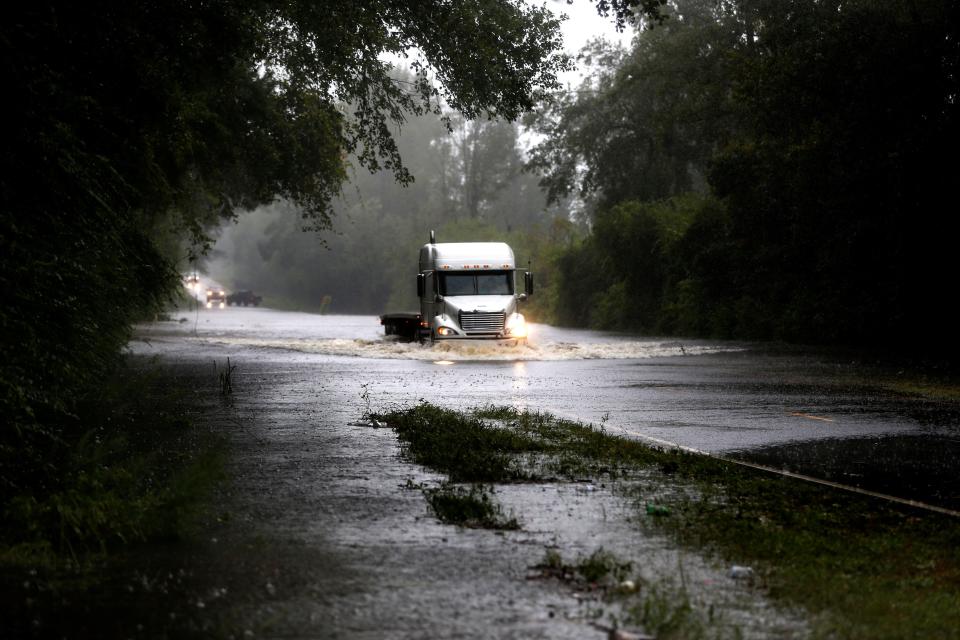 A truck goes through a flooded street during the Duplin County, North Carolina.