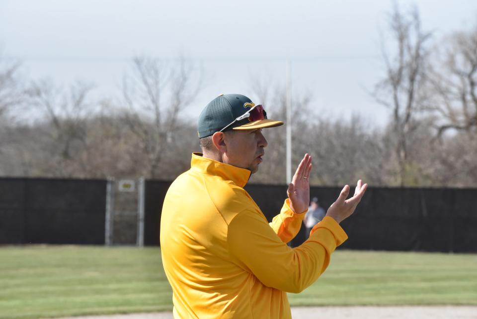 Sand Creek head coach Wayne Perry watches on from the third base box during a game against Athens.