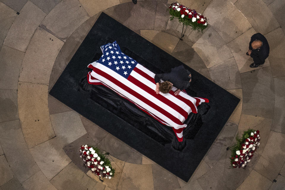 Elizabeth Dole cries on the casket of her husband, former Sen. Bob Dole, R-Kan., as he lies in state in the Rotunda of the U.S. Capitol, Thursday, Dec. 9, 2021, on Capitol Hill in Washington. (AP Photo/Andrew Harnik, Pool)