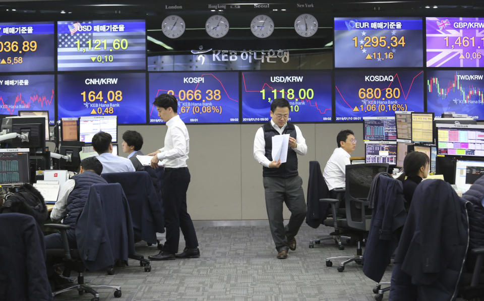 Currency traders work at the foreign exchange dealing room of the KEB Hana Bank headquarters in Seoul, South Korea, Thursday, Jan. 10, 2019. Asian markets were mostly lower Thursday as U.S. and Chinese officials wrapped up three days of talks in Beijing without significant breakthroughs. (AP Photo/Ahn Young-joon)