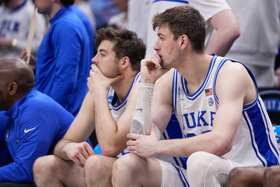 Duke's Kyle Filipowski, right, sits on the bench after fouling out against North Carolina State during the second half of an Elite Eight college basketball game in the NCAA Tournament in Dallas, Sunday, March 31, 2024. (AP Photo/Tony Gutierrez)