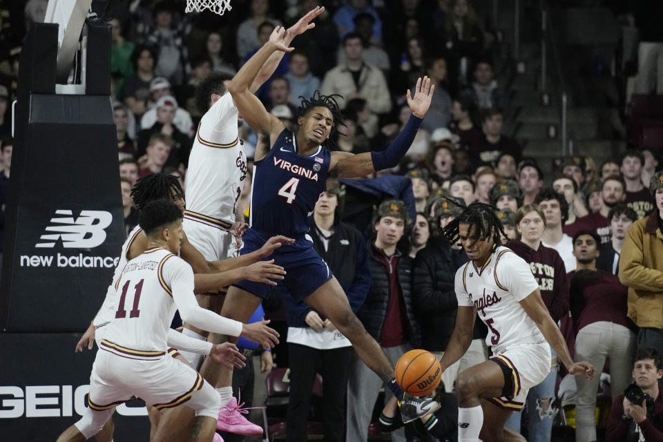 Virginia guard Armaan Franklin (4) fails to grab a rebound while surrounded by Boston College players during the second half of an NCAA college basketball game, Wednesday, Feb. 22, 2023, in Boston. (AP Photo/Charles Krupa)